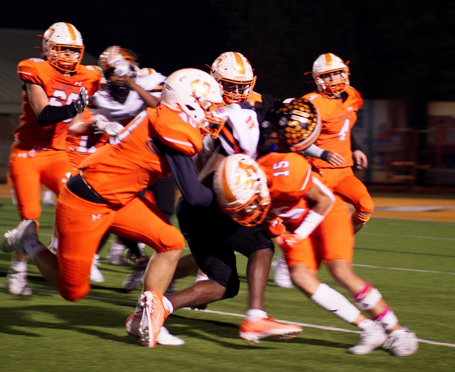 Paul Stanley and J.J. Gandy (15) converge on the Tiger ballcarrier. [See what else unfolded Friday.]